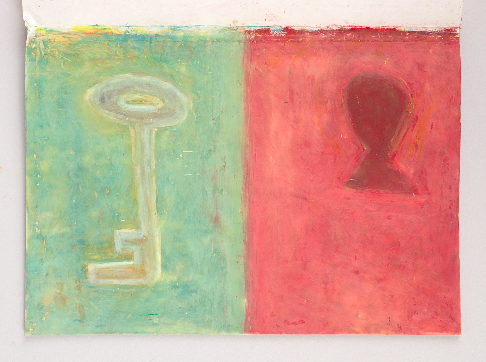 A two-panel painting lying open on a pale surface: a pale key on a green panel, beside a dark vessel on a red panel.